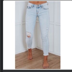 BRAND NEW, never worn light blue ripped jeans. Size 5/26 or 4ish in Women.